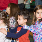 Estudiantes de En Nuestra Lengua pasan por las diferentes mesas en Bach Elementary durante la recaudación anual de fondos para el programa, que incluye la venta de comidas típicas de países de habla hispana en Bach Elementary School. Peter Matthews, Michigan Photography